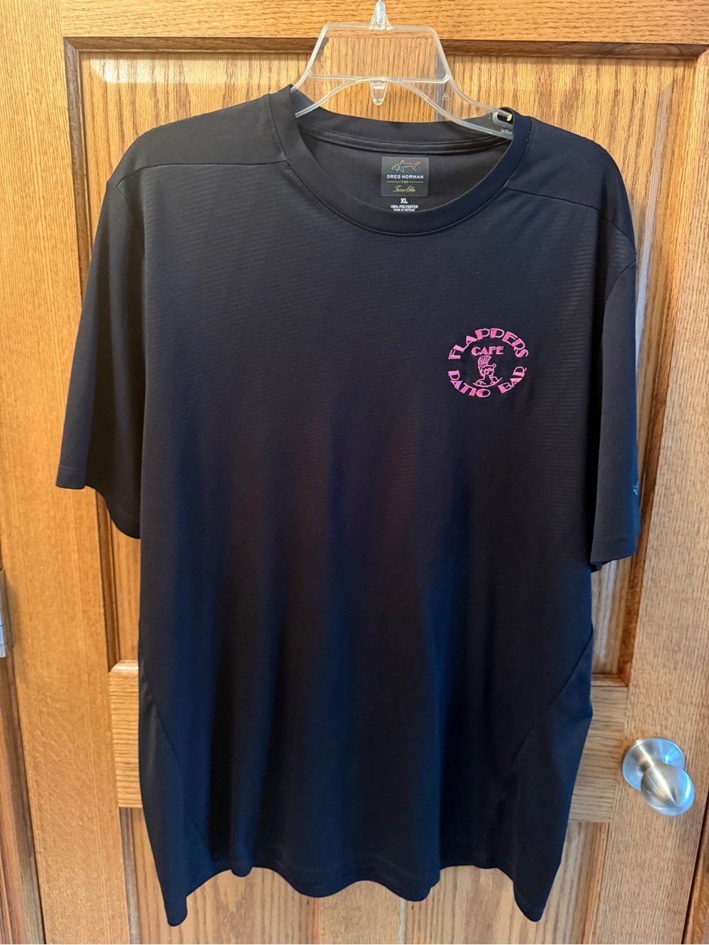 Greg Norman Collection Men’s Black Performance Tee with Pink Logo Xl